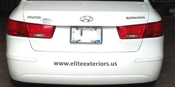 Vinyl lettering applied to a vehicle bumper displaying a business website, providing simple and effective vehicle advertising and brand recognition. 